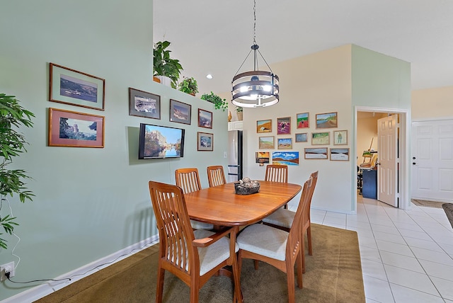 dining area featuring a high ceiling and light tile patterned floors