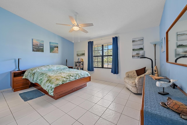 tiled bedroom featuring ceiling fan, vaulted ceiling, and a textured ceiling