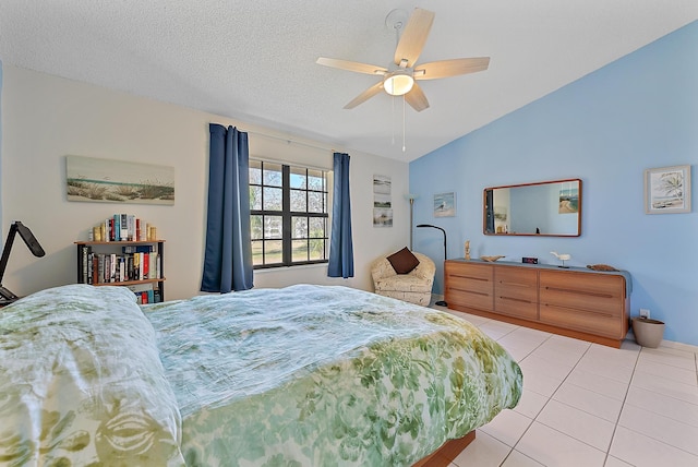 tiled bedroom with ceiling fan, lofted ceiling, and a textured ceiling