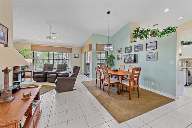 dining room with light tile patterned flooring, lofted ceiling, and ceiling fan with notable chandelier