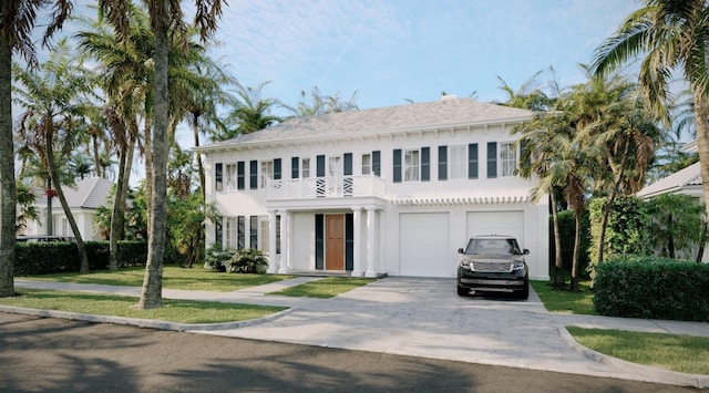 view of front facade featuring a garage and a balcony