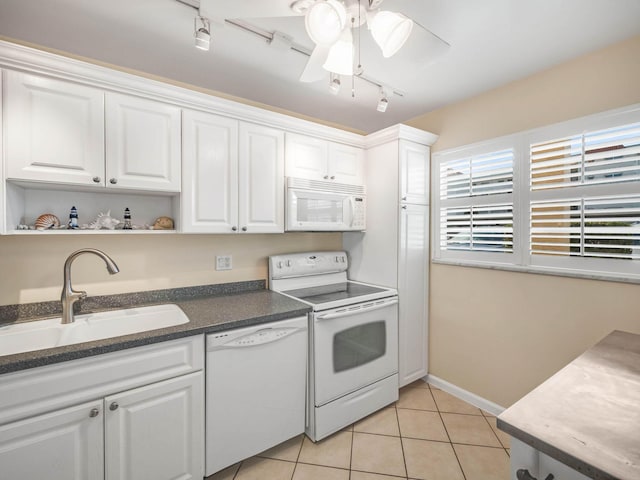 kitchen featuring sink, white cabinets, light tile patterned floors, ceiling fan, and white appliances