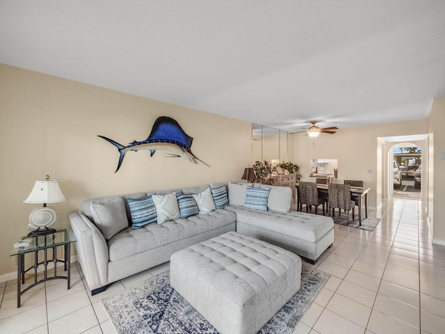 living room featuring light tile patterned floors and ceiling fan