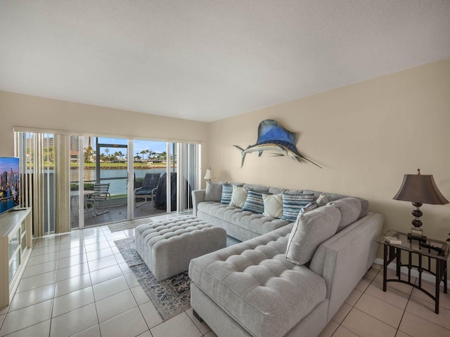 tiled living room with a water view