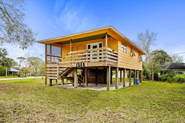 rear view of house with a patio and a yard