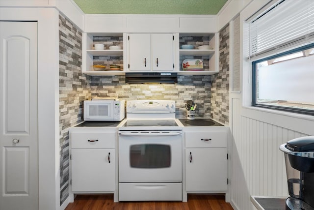 kitchen featuring white appliances, dark wood-type flooring, range hood, and white cabinets