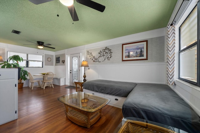 bedroom with dark hardwood / wood-style floors and a textured ceiling