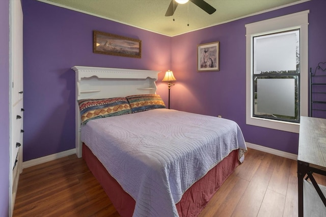 bedroom with dark hardwood / wood-style floors and ceiling fan