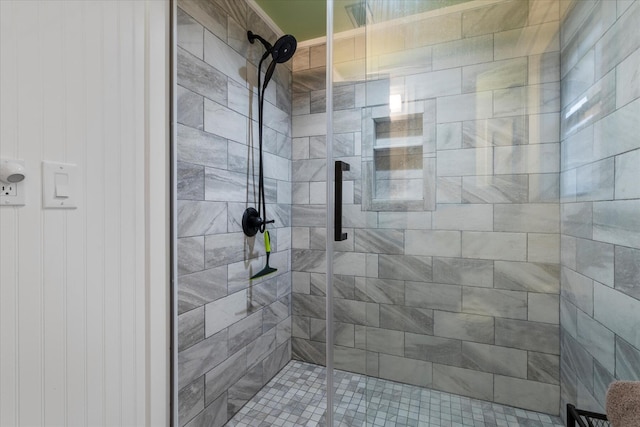 bathroom featuring a shower with door