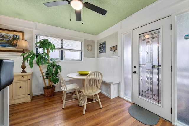 dining room featuring a textured ceiling, light hardwood / wood-style floors, and breakfast area