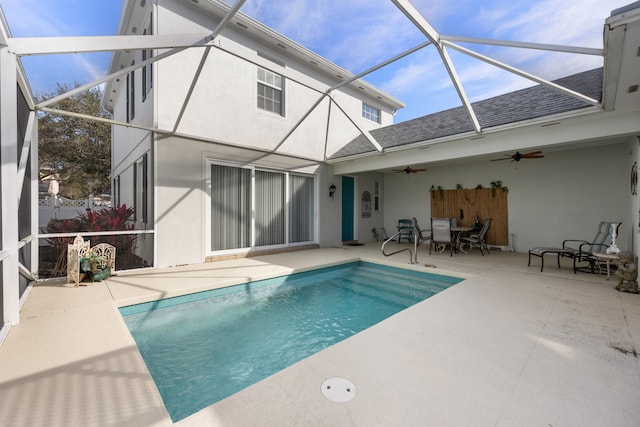 back of property with a lanai, ceiling fan, and a patio area