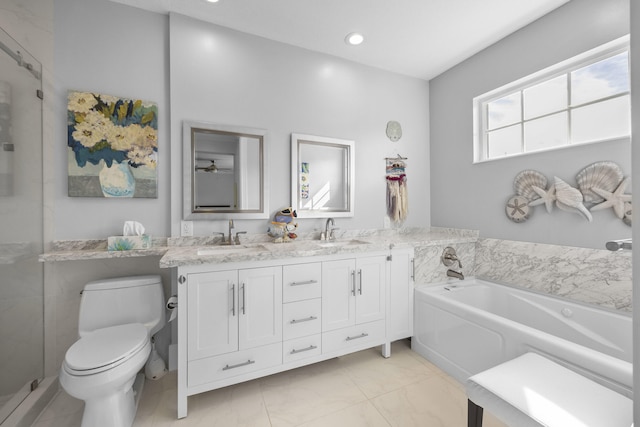 bathroom featuring vanity, toilet, and a washtub