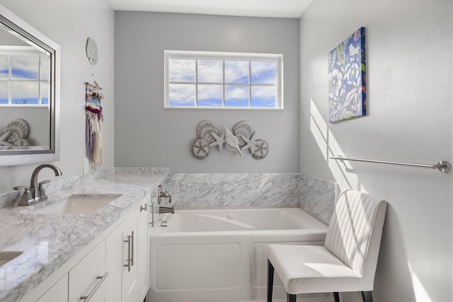 bathroom with vanity and a bathing tub