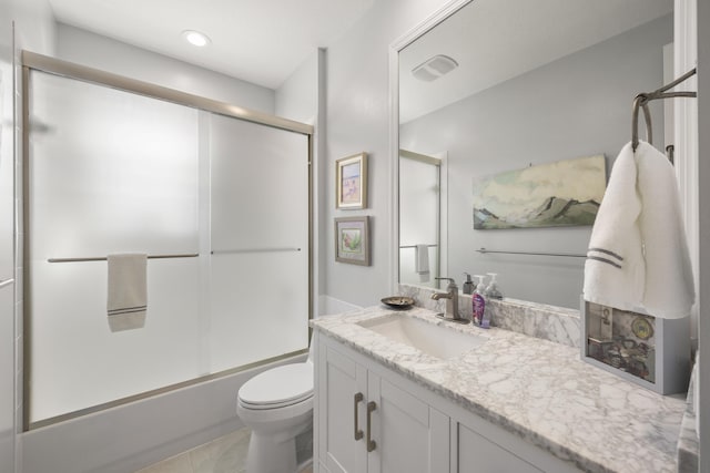 full bathroom featuring enclosed tub / shower combo, vanity, tile patterned flooring, and toilet