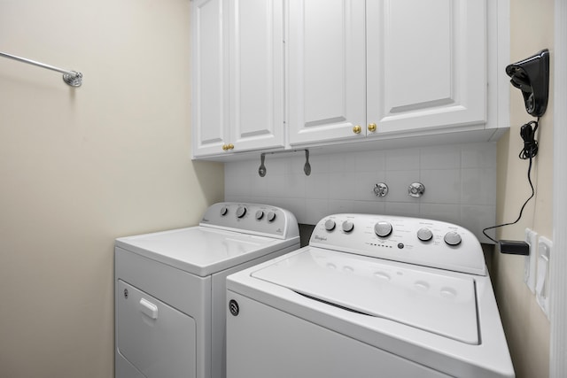 laundry room with cabinets and washing machine and clothes dryer