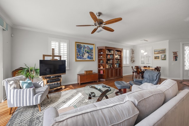 living room with crown molding, wood-type flooring, and ceiling fan