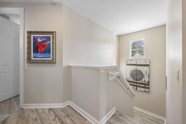 stairway with hardwood / wood-style flooring