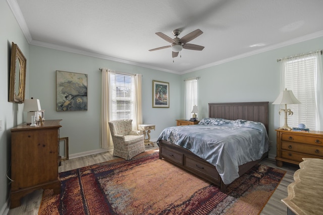 bedroom with crown molding, ceiling fan, and hardwood / wood-style floors