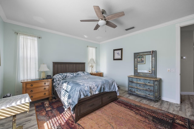 bedroom with crown molding, ceiling fan, and wood-type flooring