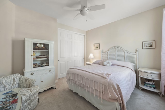 bedroom with light colored carpet, a closet, and ceiling fan