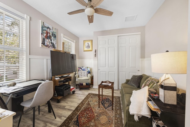 home office featuring light hardwood / wood-style floors and ceiling fan