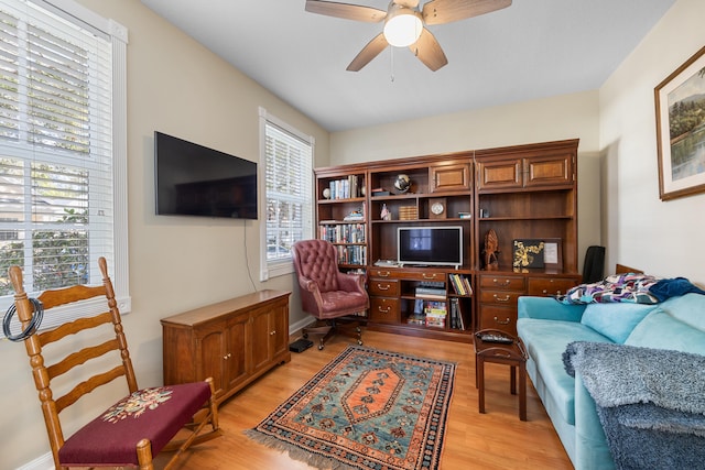 living area featuring ceiling fan and light hardwood / wood-style floors