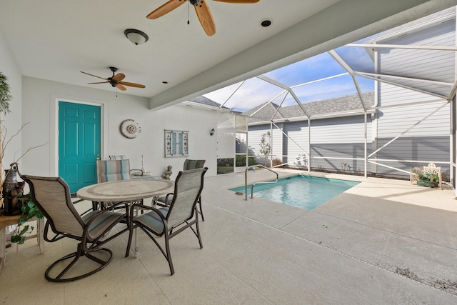 view of swimming pool with a patio, a lanai, and ceiling fan