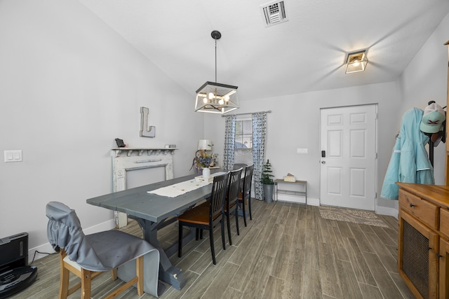 dining room featuring lofted ceiling and a chandelier