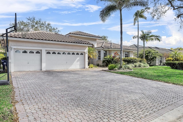 view of front of property featuring a garage and a front lawn