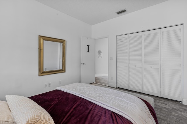 bedroom featuring hardwood / wood-style floors and a closet