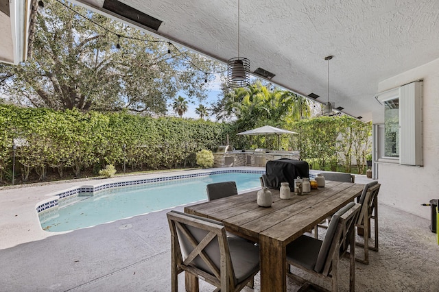 view of swimming pool featuring a grill and a patio