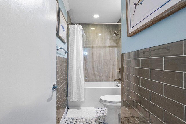 bathroom featuring tile walls, tile patterned floors, toilet, and shower / bathtub combination with curtain