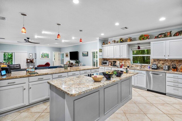 kitchen with pendant lighting, light tile patterned floors, dishwasher, white cabinetry, and a center island