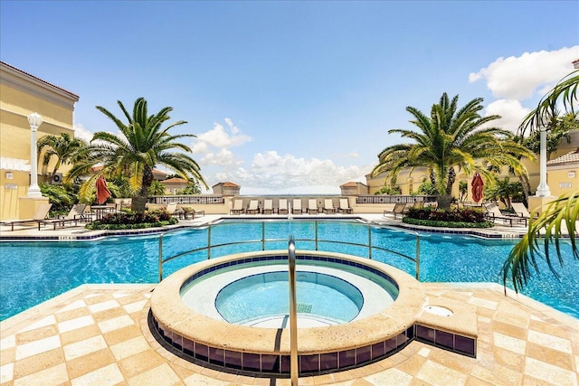 view of pool with a community hot tub and a patio area