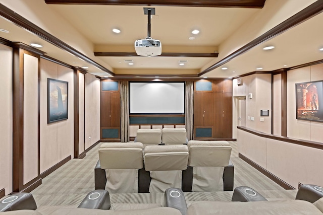 cinema room featuring light colored carpet and beam ceiling