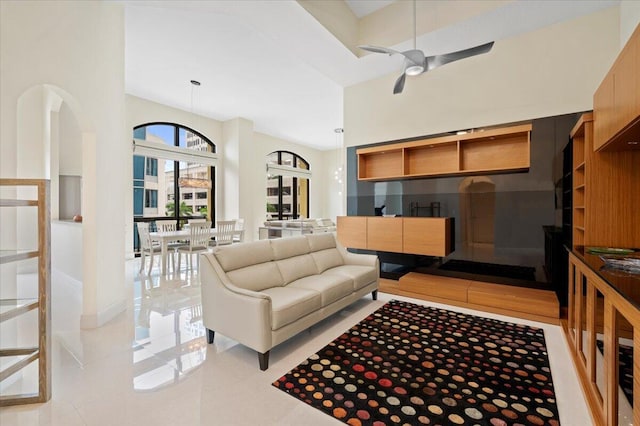 tiled living room with ceiling fan