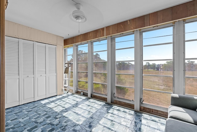 sunroom / solarium with ceiling fan and plenty of natural light