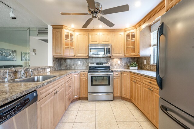 3021 Ventnor Cres, Deerfield Beach, FL 33442 - kitchen featuring appliances with stainless steel finishes, a sink, light tile patterned floors, decorative backsplash, and ceiling fan
