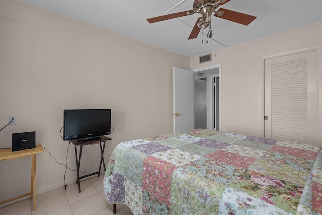 tiled bedroom with ceiling fan