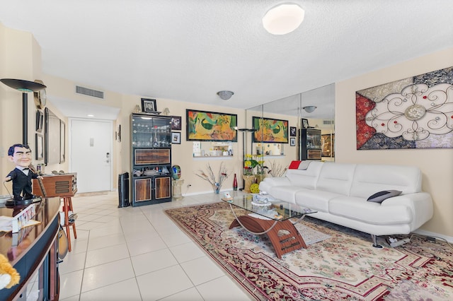 living room featuring light tile patterned flooring and a textured ceiling