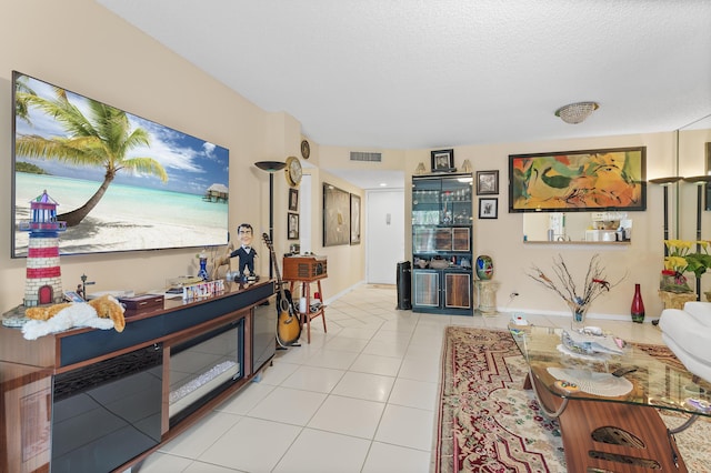 tiled living room with a textured ceiling