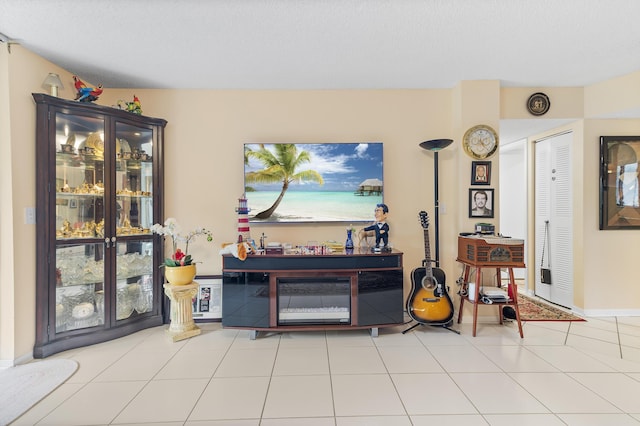 living room with light tile patterned floors and a textured ceiling