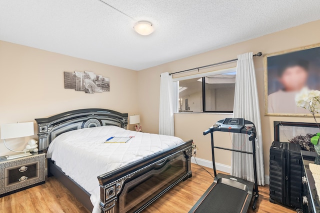 bedroom featuring a textured ceiling and light wood-type flooring