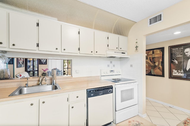 kitchen with sink, white appliances, white cabinets, and light tile patterned flooring