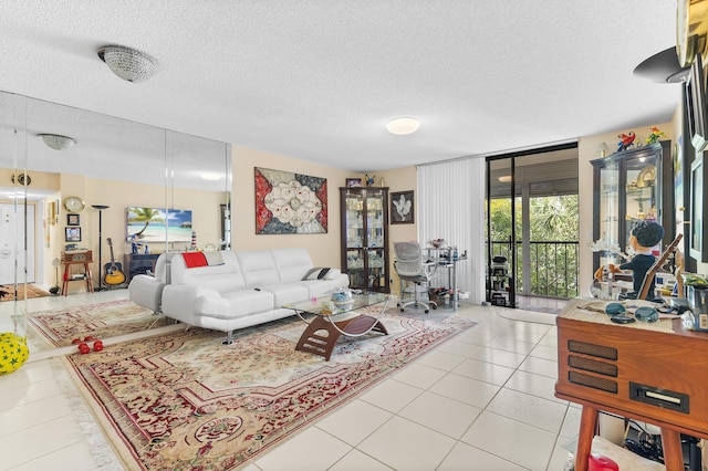 tiled living room featuring floor to ceiling windows and a textured ceiling