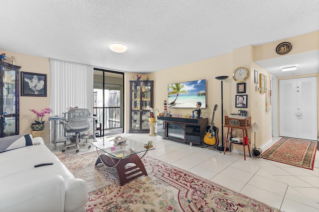 tiled living room featuring a textured ceiling