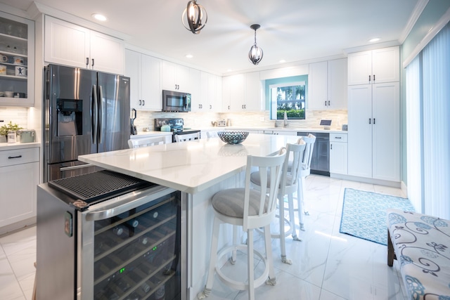 kitchen featuring wine cooler, appliances with stainless steel finishes, decorative light fixtures, and a center island