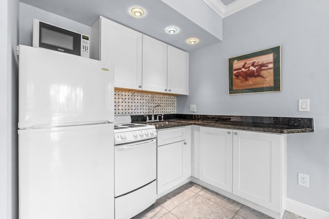 kitchen with white cabinets, white appliances, and dark stone counters