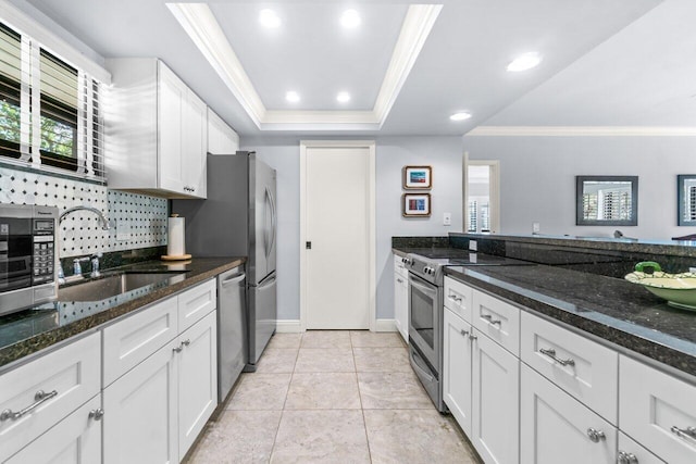 kitchen featuring appliances with stainless steel finishes, sink, and white cabinets