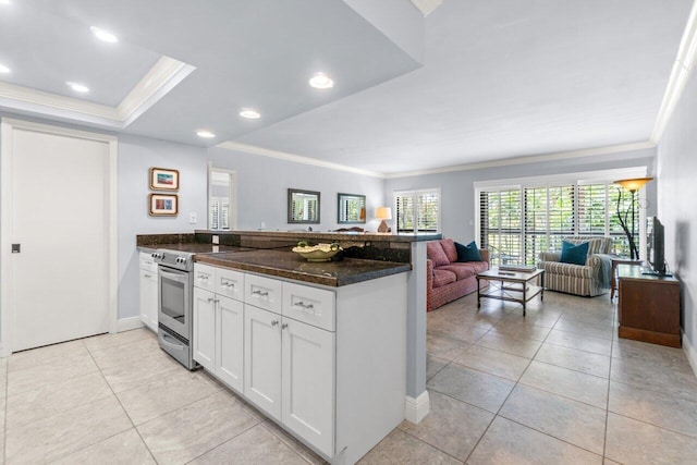 kitchen featuring white cabinetry, stainless steel electric stove, dark stone counters, and kitchen peninsula